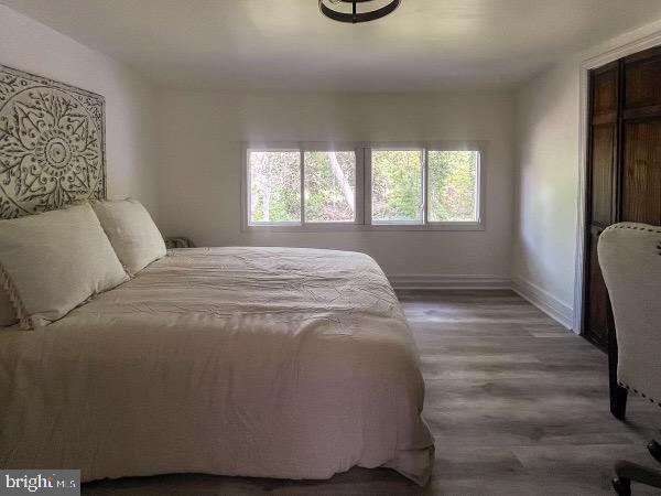 517 S Ave, Bridgeton, NJ 08302 - bedroom featuring baseboards, multiple windows, and wood finished floors