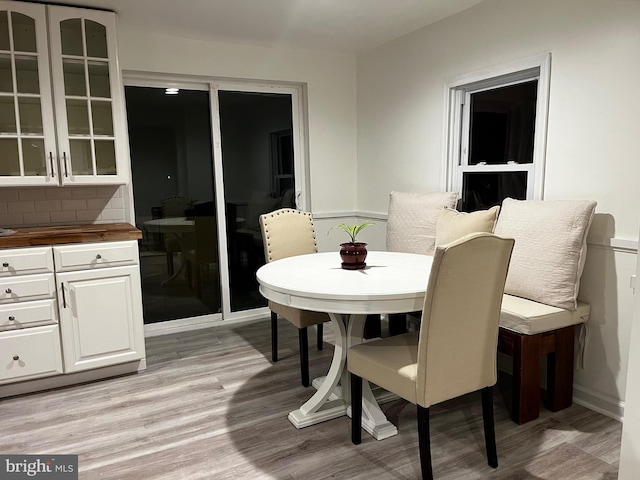 dining space with light hardwood / wood-style flooring