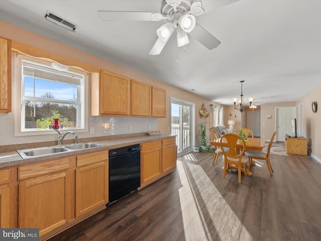 kitchen featuring hanging light fixtures, sink, black dishwasher, and a wealth of natural light