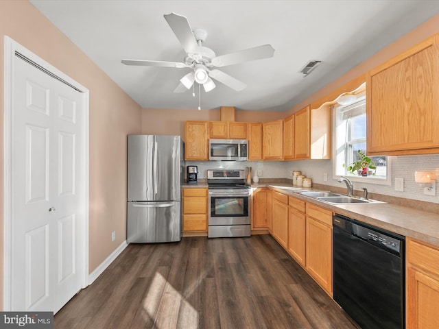 kitchen featuring ceiling fan, sink, light brown cabinets, dark wood-type flooring, and appliances with stainless steel finishes