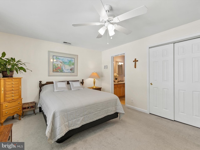 carpeted bedroom featuring connected bathroom, ceiling fan, and a closet