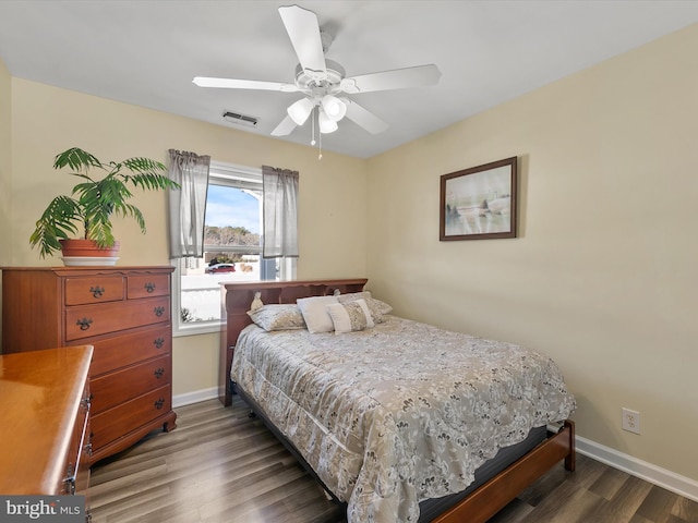 bedroom with ceiling fan and dark hardwood / wood-style floors