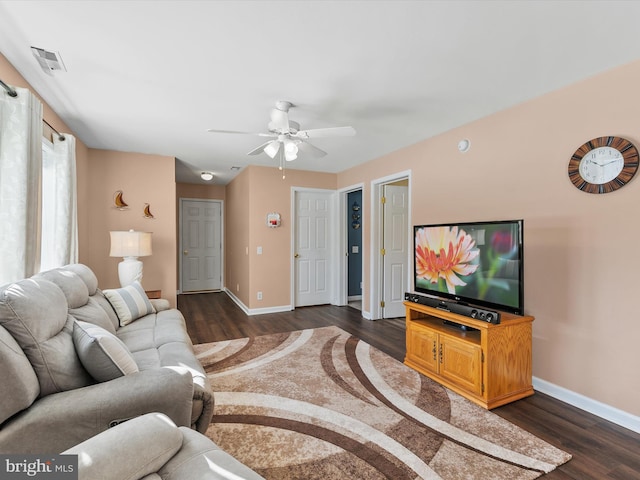 living room with ceiling fan and dark hardwood / wood-style floors