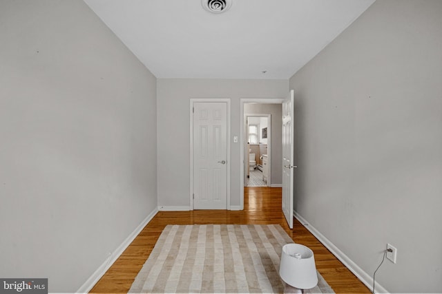 unfurnished room with hardwood / wood-style flooring