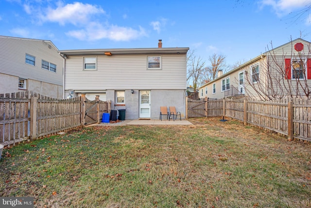 back of property featuring a yard and a patio