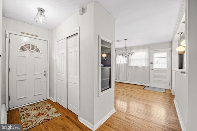 entrance foyer featuring a chandelier and light wood-type flooring