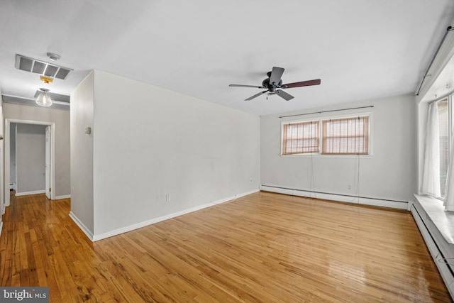 unfurnished room with ceiling fan, light hardwood / wood-style floors, and a baseboard heating unit