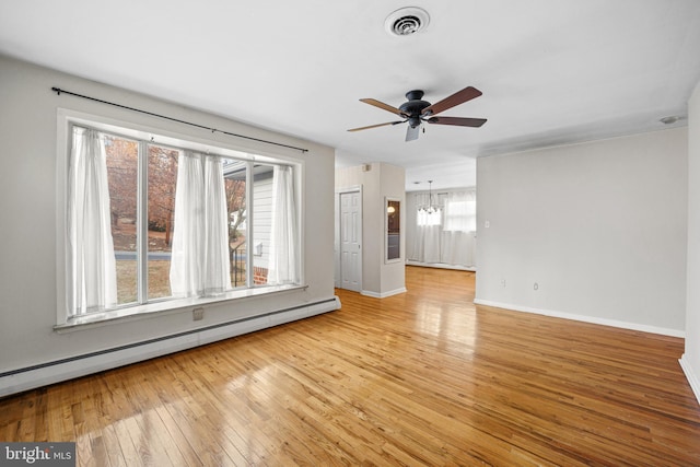 unfurnished living room featuring baseboard heating, light hardwood / wood-style floors, and ceiling fan with notable chandelier