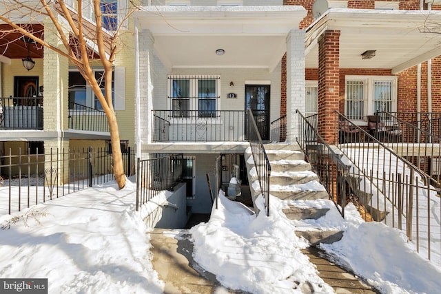 view of snow covered property entrance