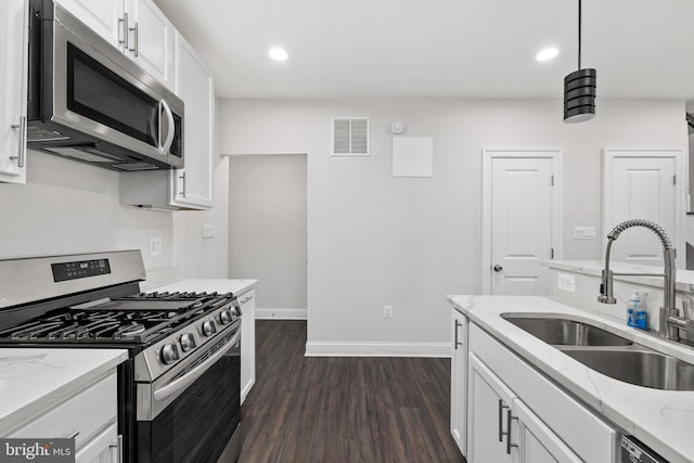 kitchen featuring sink, stainless steel appliances, white cabinets, and light stone countertops