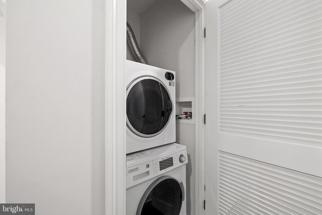 washroom featuring stacked washer and dryer