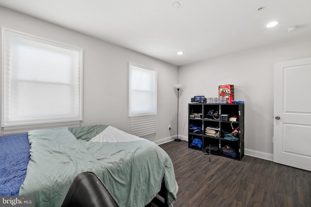 bedroom with dark wood-type flooring