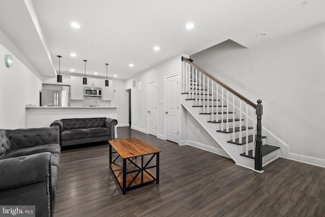 living room with dark hardwood / wood-style flooring