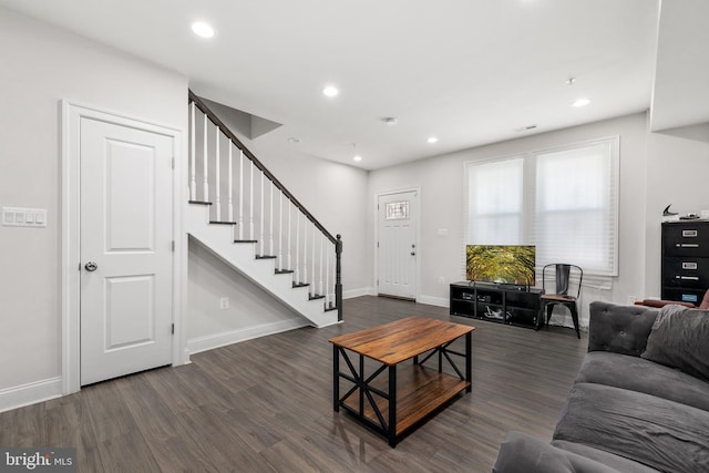 living room with dark hardwood / wood-style flooring