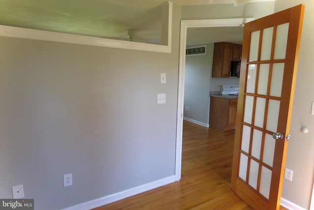 hall with light wood-type flooring