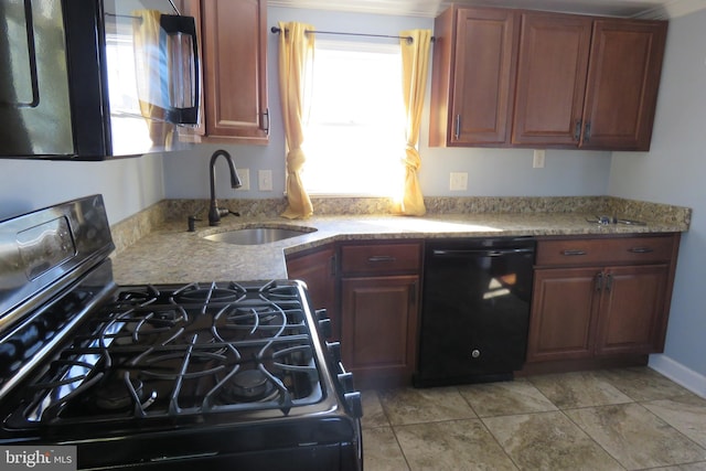 kitchen with light stone countertops, light tile patterned floors, sink, and black appliances