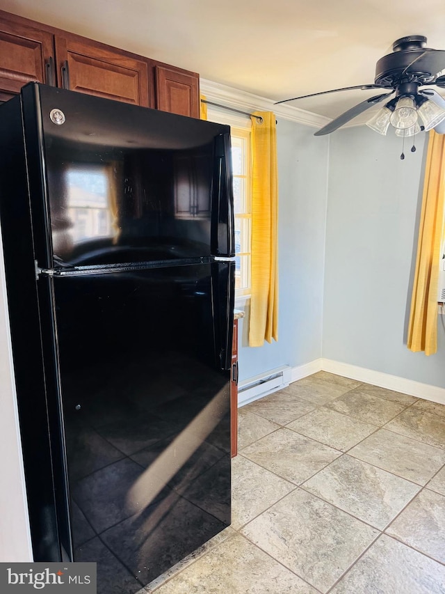 kitchen featuring ceiling fan, black fridge, crown molding, and a baseboard radiator