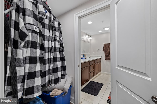 bathroom featuring tile patterned flooring and vanity