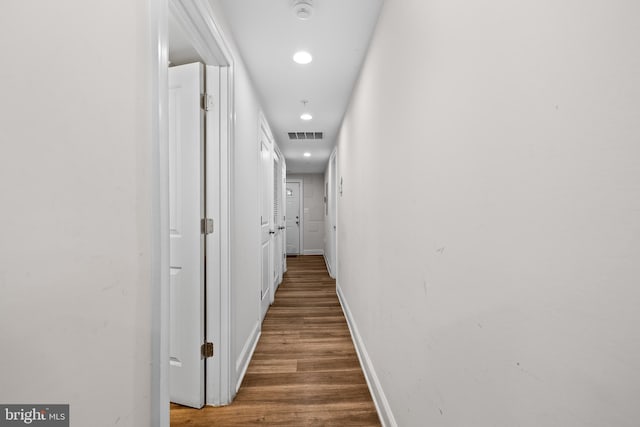 corridor featuring dark hardwood / wood-style flooring