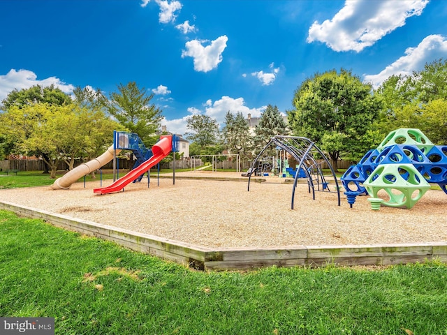 community jungle gym with a lawn and fence