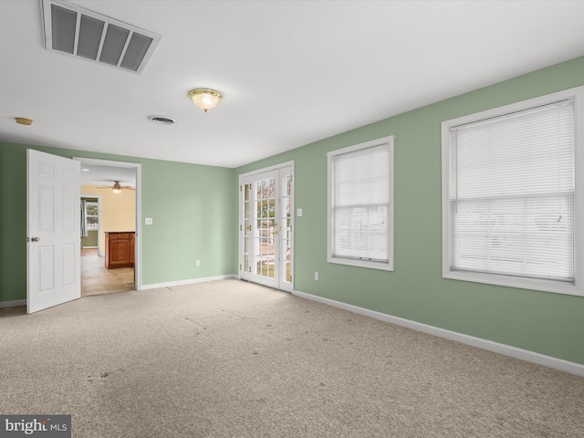 carpeted empty room with baseboards and visible vents