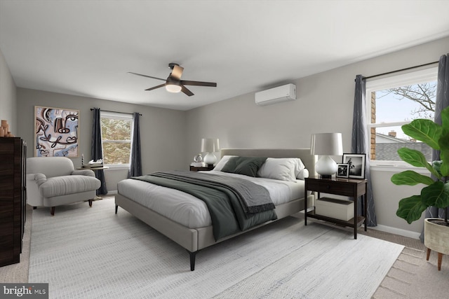 bedroom featuring ceiling fan, baseboards, carpet flooring, and a wall mounted AC