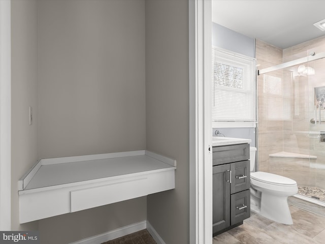 bathroom with a stall shower, visible vents, vanity, and toilet