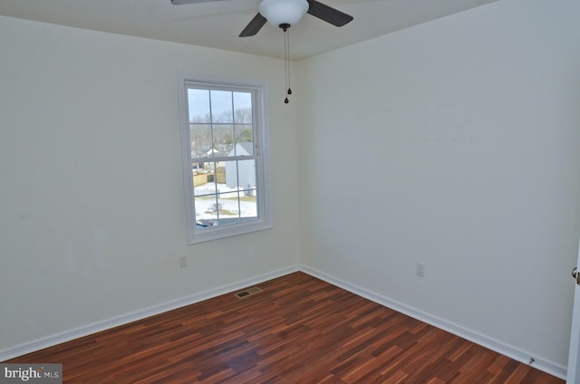 spare room featuring ceiling fan and dark hardwood / wood-style flooring