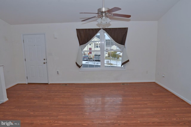 spare room with ceiling fan and wood-type flooring