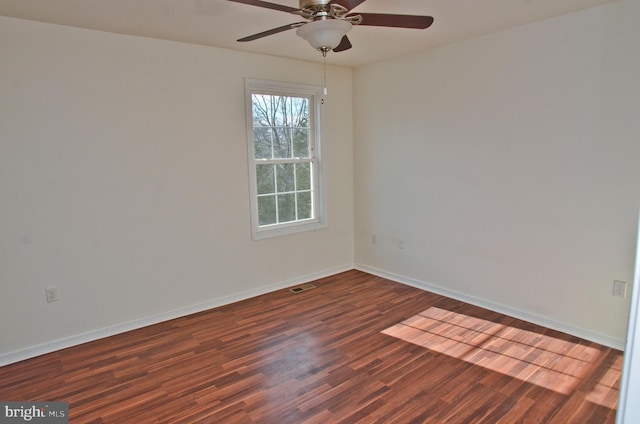 unfurnished room with ceiling fan and dark hardwood / wood-style flooring