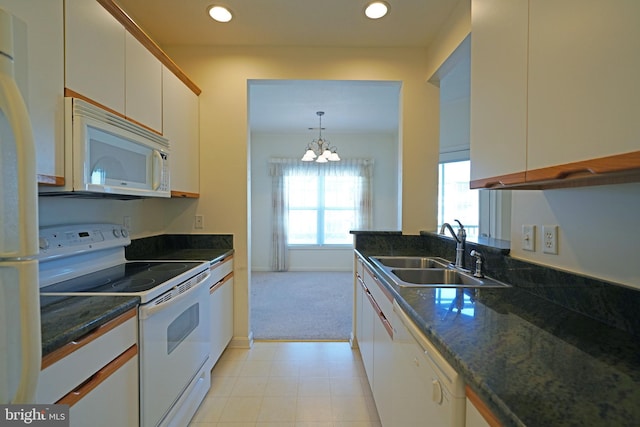 kitchen featuring white cabinetry, sink, a chandelier, decorative light fixtures, and white appliances