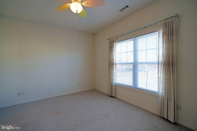 unfurnished room featuring light carpet and ceiling fan