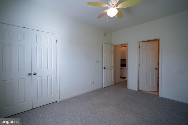 unfurnished bedroom with ceiling fan, a closet, and light carpet