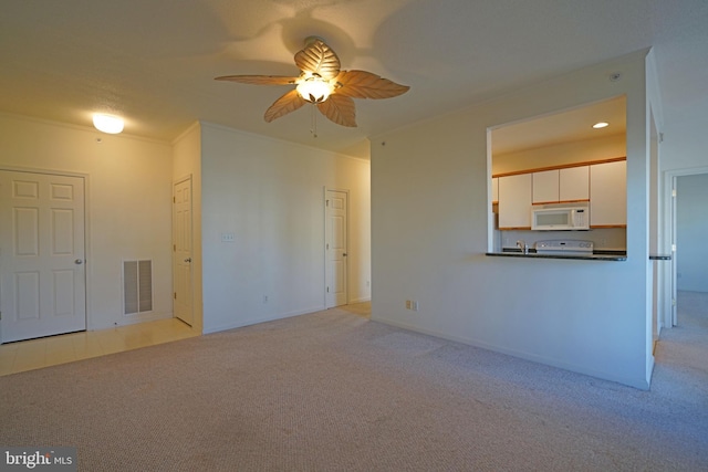 unfurnished living room featuring ceiling fan, crown molding, and light carpet