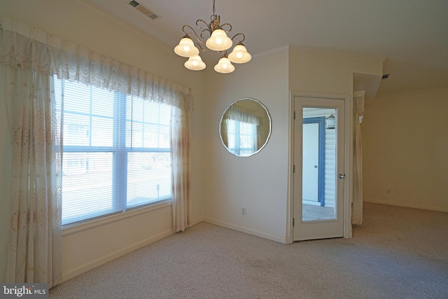 interior space with light carpet, a chandelier, and ornamental molding