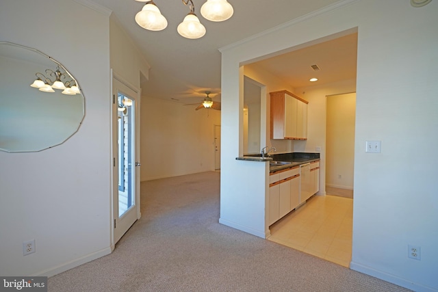 kitchen with light carpet, ornamental molding, ceiling fan with notable chandelier, pendant lighting, and dishwasher