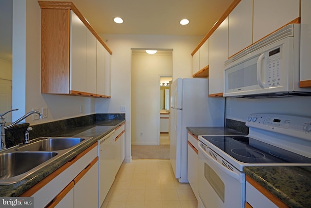 kitchen featuring white appliances, white cabinetry, and sink