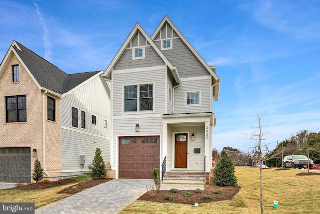 view of front of home with a front lawn and a garage