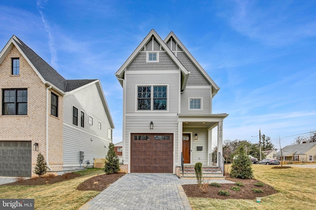 view of front of home with a garage and a front lawn