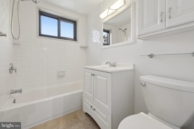 full bathroom featuring tile patterned flooring, tiled shower / bath, vanity, and toilet