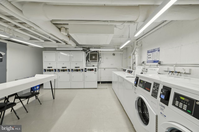 washroom with washing machine and clothes dryer and stacked washer and clothes dryer