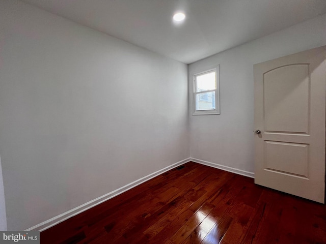 empty room with dark hardwood / wood-style floors