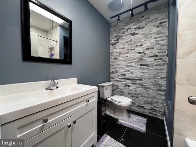 bathroom featuring vanity, toilet, and walk in shower