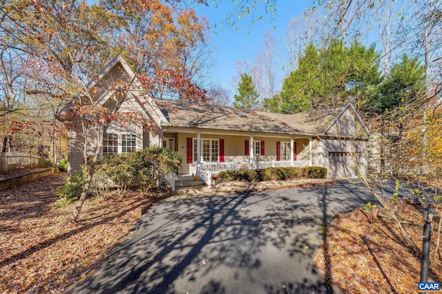 view of front of property with a porch and a garage