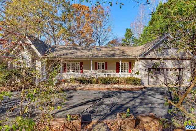 ranch-style house with covered porch and a garage