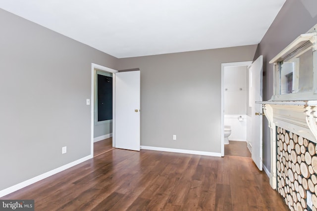 unfurnished bedroom with dark wood-type flooring