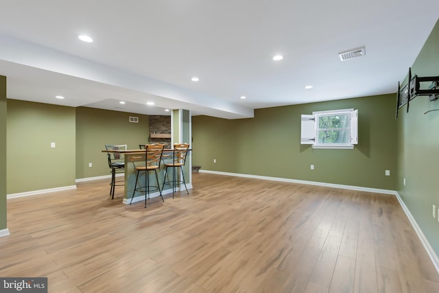 interior space featuring indoor bar and light wood-type flooring