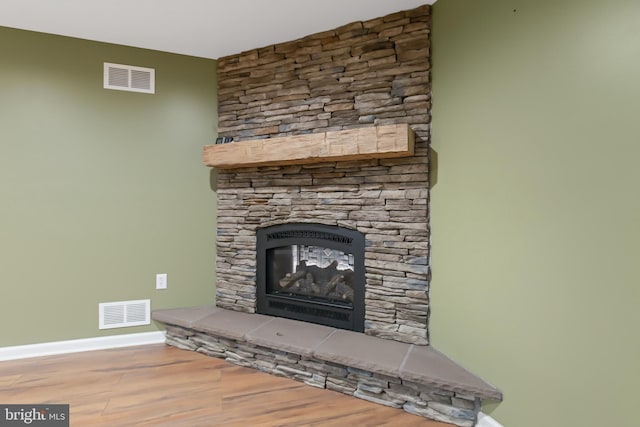 room details with a fireplace and hardwood / wood-style flooring