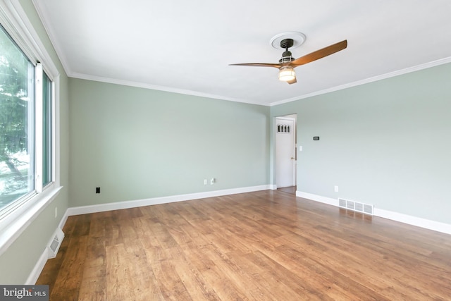 empty room featuring light wood-type flooring, ceiling fan, and crown molding