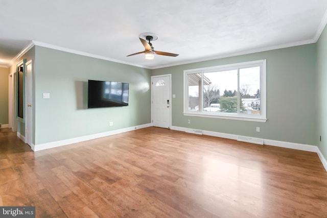 unfurnished living room featuring light hardwood / wood-style flooring, ceiling fan, and crown molding